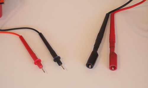 Standard digital multimeter test leads on left, upgraded leads with alligator clip attachments on right