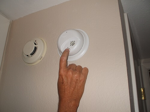 Press and hold the smoke detector "Test" button until the unit sounds