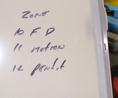 Zone list written inside lid of an Ademco Vista 10SE using 3 of its 6 available zones