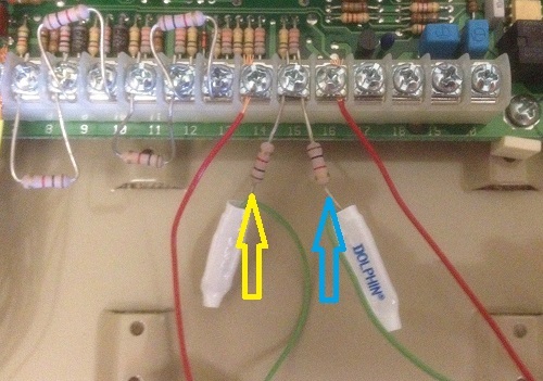 Alarm panel wiring showing Common Ground and Zone terminals. Arrows point to end-of-line resistors