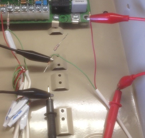 Close-up of security alarm wiring connected to meter probes. Notice that the EOLR is not being metered, just the wires.