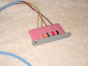 Alarm programming connector with keeper attached