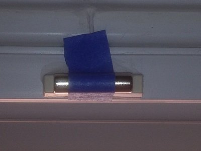 Surface-mount switch with magnet taped parallel with switch