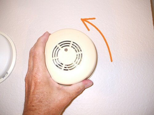 Remove old electric smoke alarm by rotating counterclockwise
